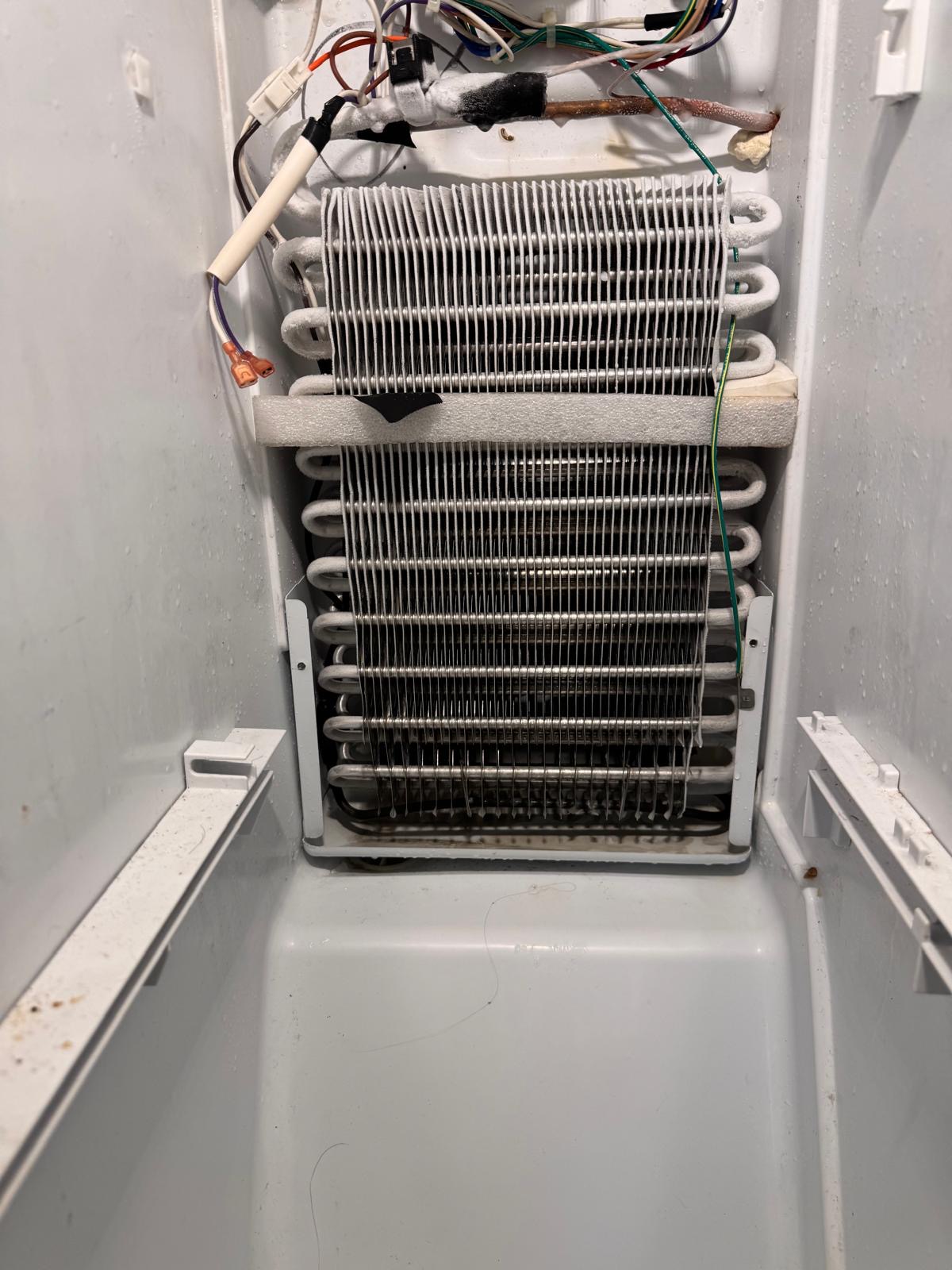 Exposed evaporator coil during a cooling service visit